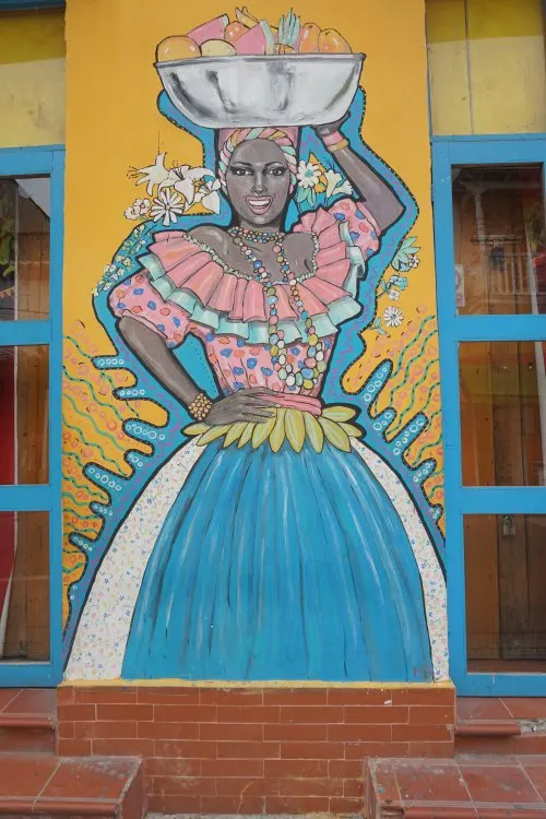 A street art mural of a palenquera or fruit vendors in Cartagena, Colombia. 