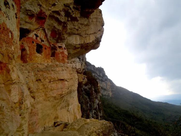 The painted mausoleums of Revash perched in the cliff above the valley near Chachapoyas Peru