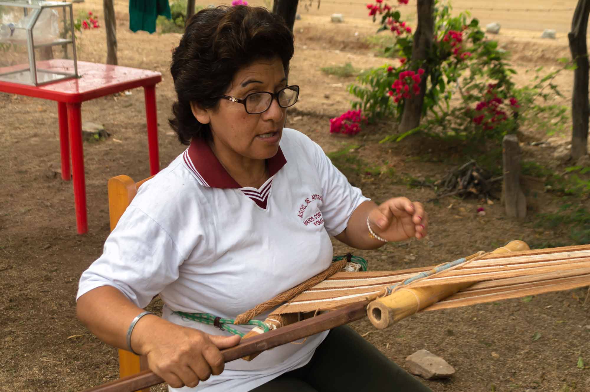 A weaver makes textiles using organic, wild cotton in the Bosque de Pomac in northern Peru, a responsible tourism destination in South America