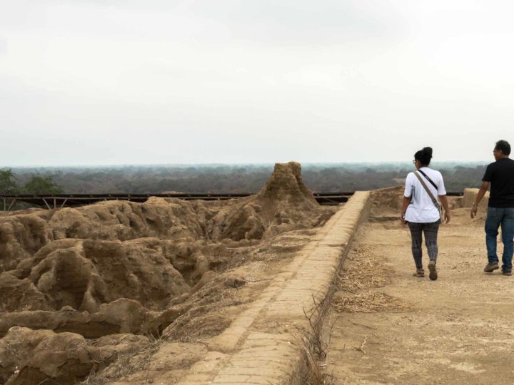 Two people walk on the walls of the Huaca Las Ventanas in what is now the Santuario Historico Bosque de Pomac in northern Peru. 