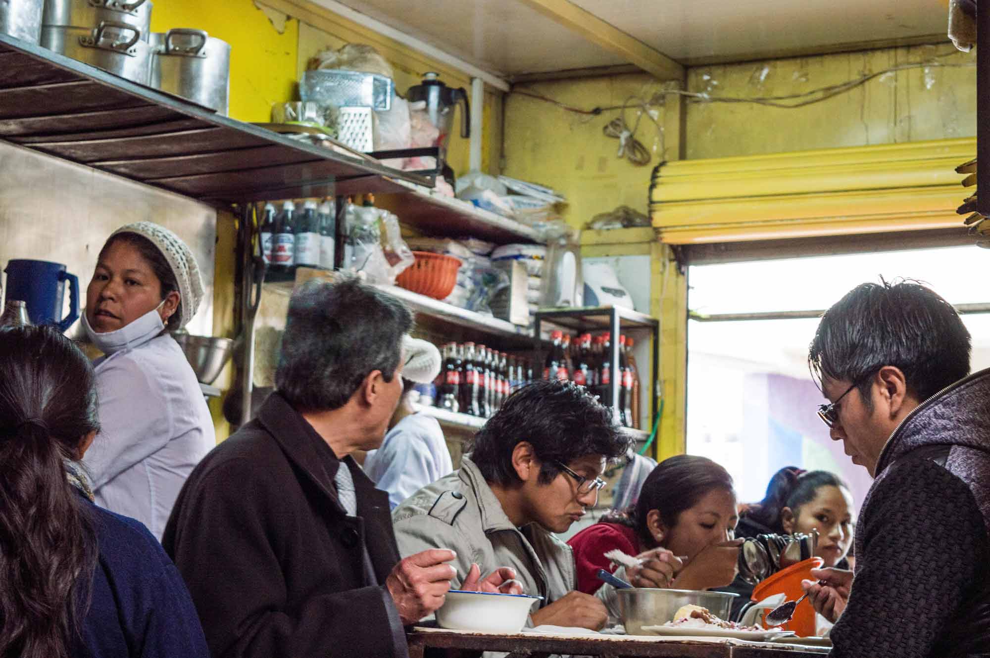 Local diners eating in the Mercado Lanza in La Paz, a great opportunity to meet local people and spend your money in a responsible tourism fashion