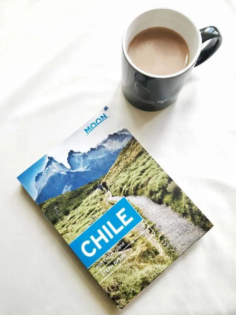 Moon Chile guidebook next to a cup of tea