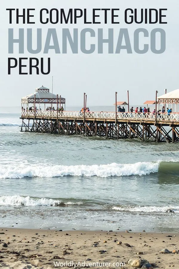 The Huanchaco pier filled with walking tourists extends out over the ocean
