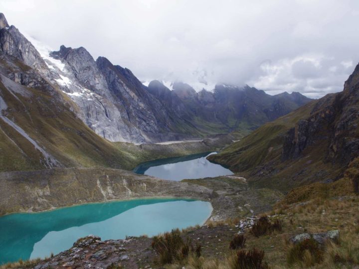 Glacial lakes overlook the long valley and mountain peaks of Cordillera Huayhuash in Peru. This region has some of the best treks in South America