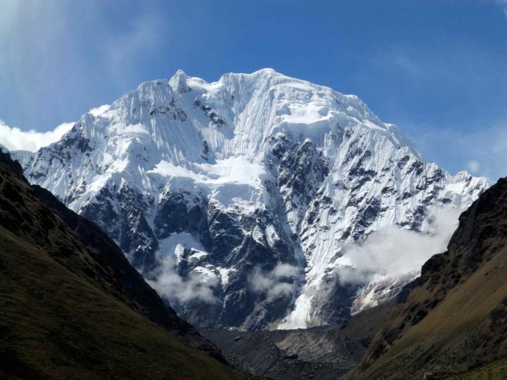 The snow covered peaks of Salkantay peer out from behind grassy lower slopes. Peru is considered one of the best places to hike in South America.