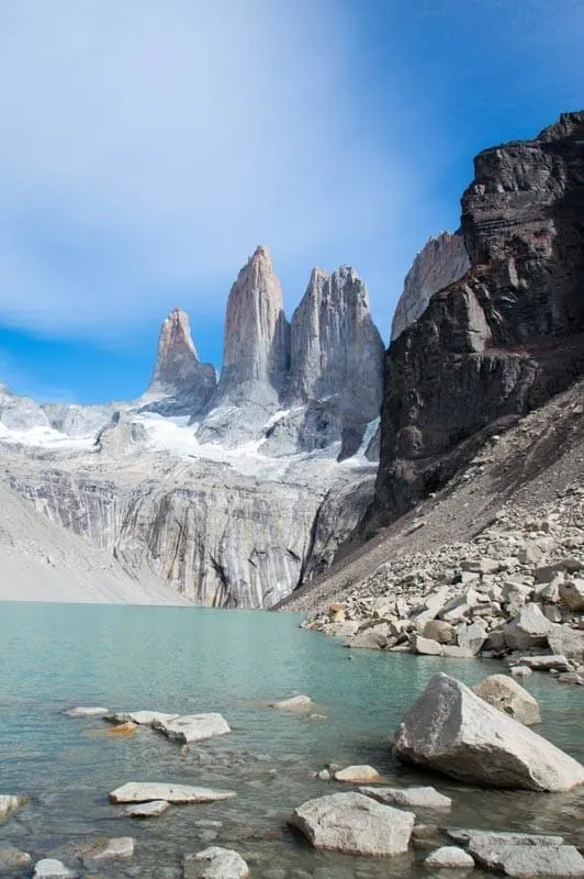 The jagged mountain peaks of the Torres del Paine overlook a glacial lake in Chile. This mountain offers some of the best hiking in South America.