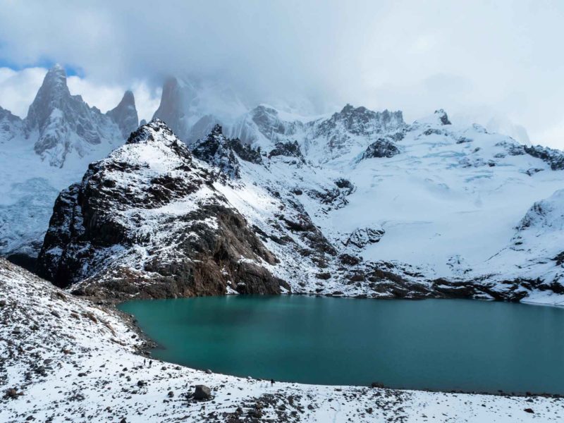 Mountains overlook a brilliant turquoise lake in El Chalten Argentina on this South America Backpacking Route.