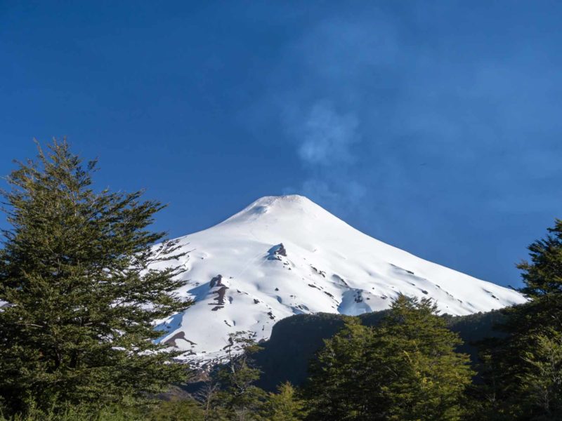Snow covered Volcan Villarrica is a must-see if you're Backpacking in South America.