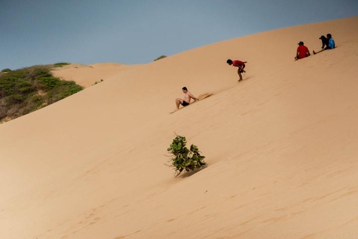 Sandboard down the sand dunes at Punta Gallinas in the La Guajira Peninsula, an unmissable place to visit in Colombia