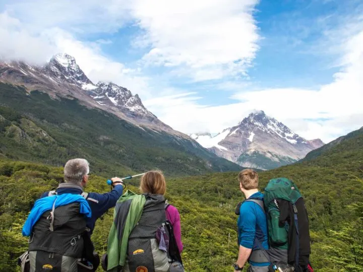 Three hikers look at the path out of Campamento Dickson while hiking the O Circuit in Torres del Paine National Park, Patagonia
