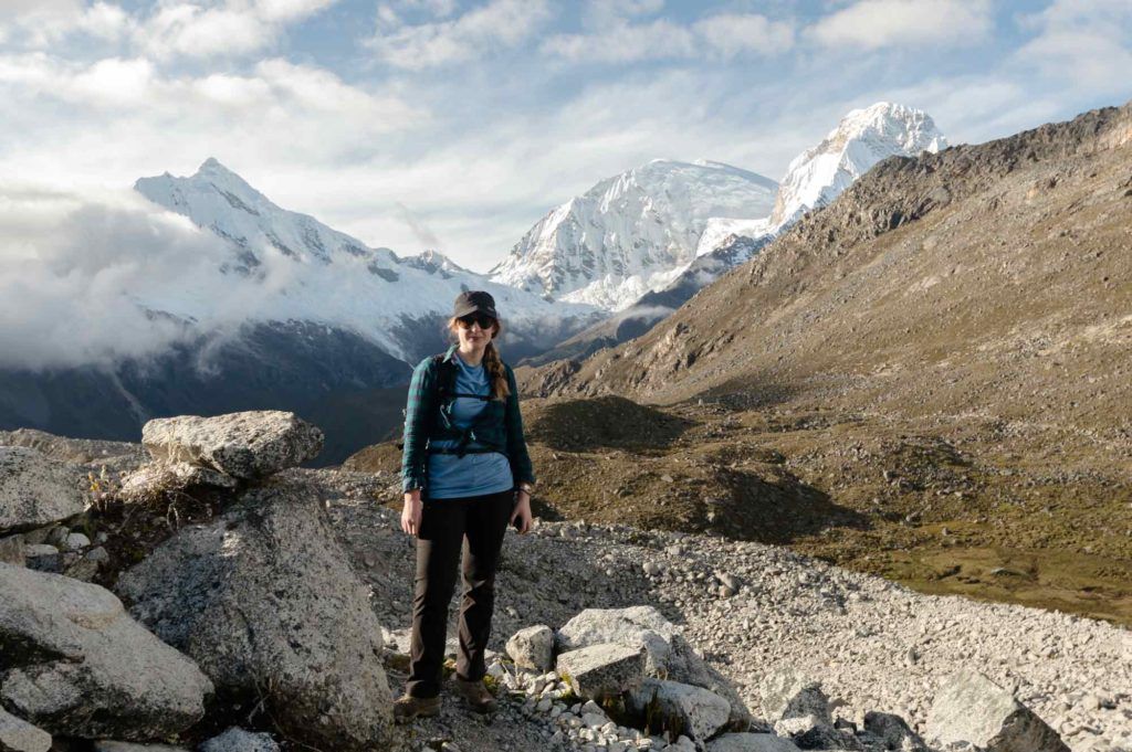 Steph Dyson, Peru trip planner, standing in front of snowy mountains in Huaraz