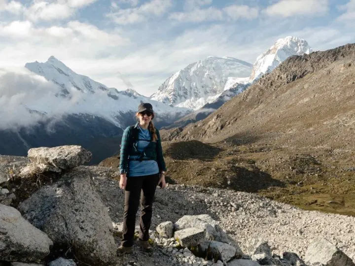 Steph Dyson, Peru trip planner, standing in front of snowy mountains in Huaraz