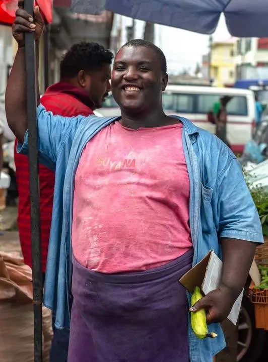 A man poses for the camera in Bourda Market, Georgetown, Guyana's capital city