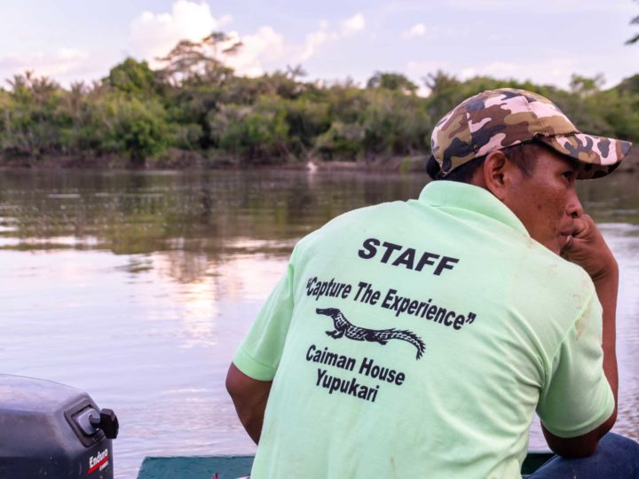 A staff member at Caiman House on an expedition to capture a caiman for scientific research in Guyana