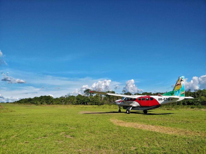 A light aircraft on a dirt runway in Guyana, South America
