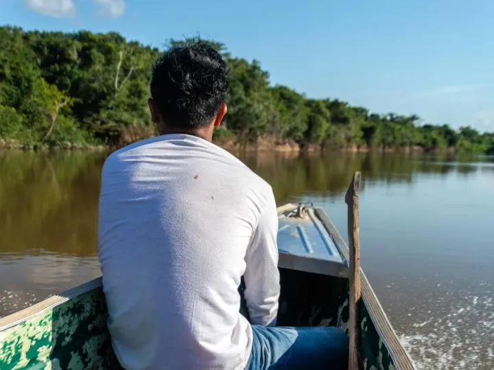 A boat glides down a river in Guyana, South America