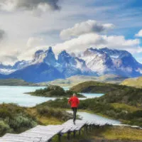 A person runs down a wooden boardwalk at the Salto Chico viewpoint in Torres del Paine National Park, a short day hike