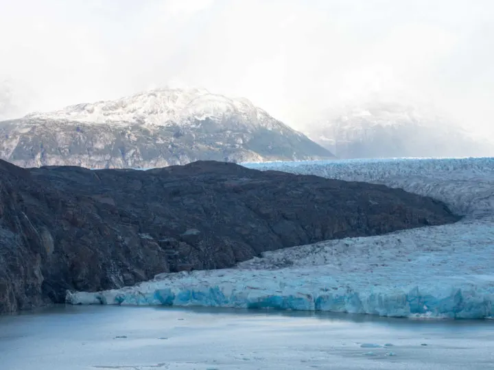 One Torres del Paine Day Hike take you to see this glacier curving through the mountains into the waters of Lago Grey