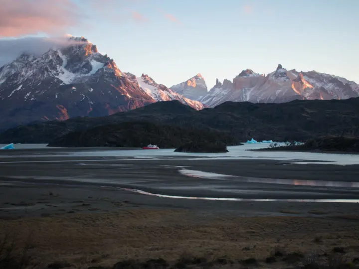 Icebergs float in the quiet waters at sunset on Lago Grey, seen from a viewpoint in Torres del Paine National Park, Patagonia