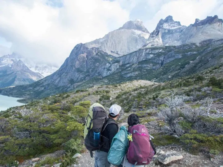 Two hikers with day packs on the trails in Torres del Paine National Park, Patagonia