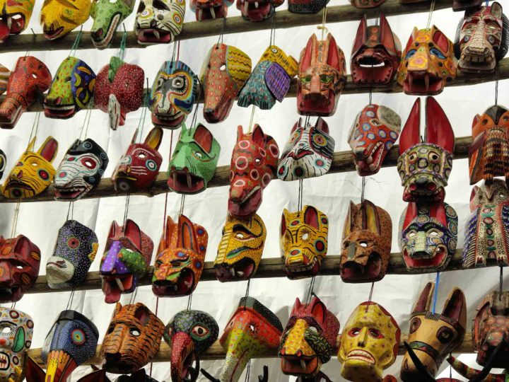 Wooden masks on display at a Guatemalan market