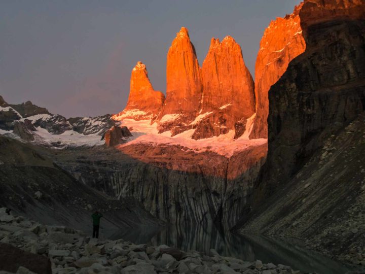 The towers in Torres del Paine National Park lit up in red at dawn