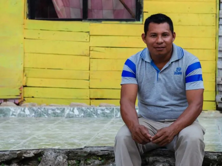 Wilfrido Perez Lucas, a Zenu indigenous leader in Cartagena, Colombia, sits on a step