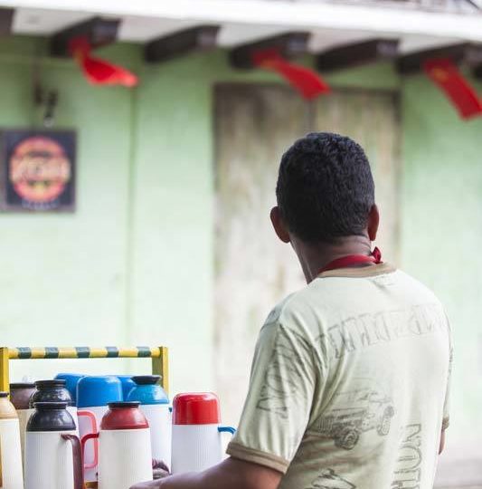 A tinto seller or coffee seller stands by his cart in Cartagena, Colombia