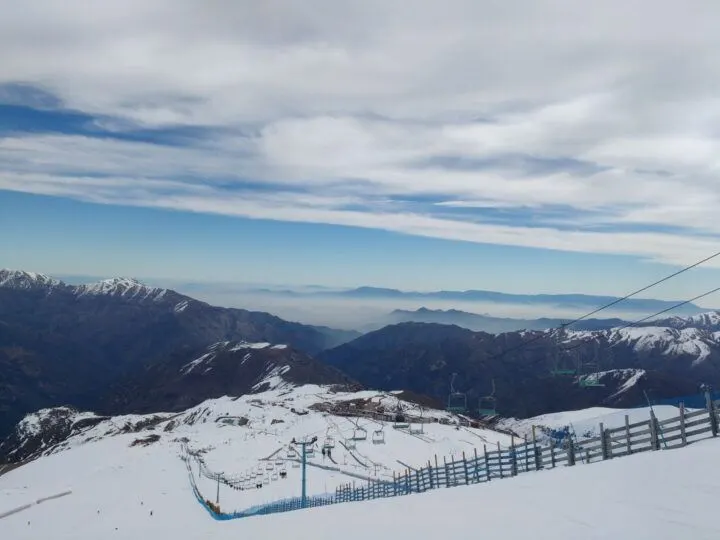 Views of a ski slope and Santiago in the background from the slopes of Valle Nevado, a fantastic winter day trip from Santiago, Chile