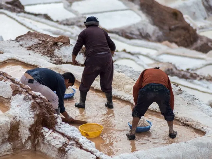 Local people panning for salt at the centuries-old Salinas de Maras in the Sacred Valley in Peru