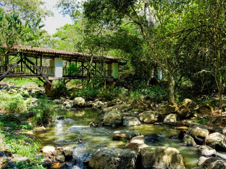 An old bridge surrounded by the lush greenery of  Gallineral Park in San Gil, Colombia.