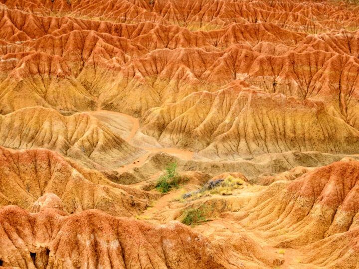 An aerial view of the orange, red and yellow rock in the Tatacoa Desert, Colombia