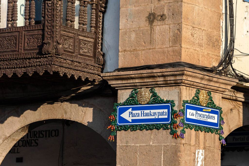 A pretty street sign on the corner of the Plaza de Armas in Cusco, Peru