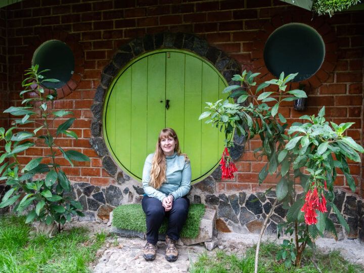 Steph Dyson from Worldly Adventurer sits in front of a hobbit house on day three of the Salkantay trek to Machu Picchu, Peru