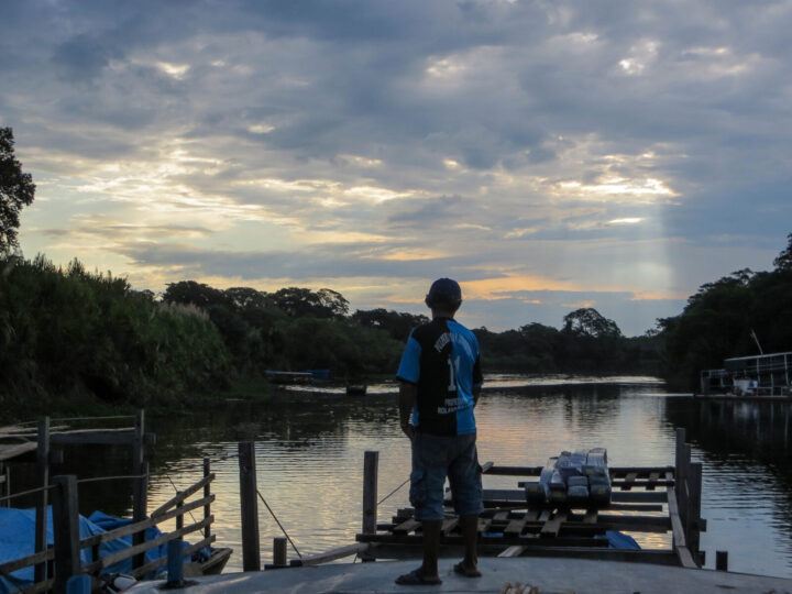 A member of the cargo boat crew stares ahead across the River Manmore in the Bolivian Amazon. 
