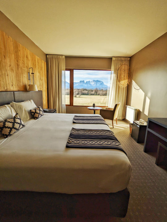 A bedroom with views of Los Cuernos in the Rio Serrano Hotel + Spa in Torres del Paine National Park, Chile