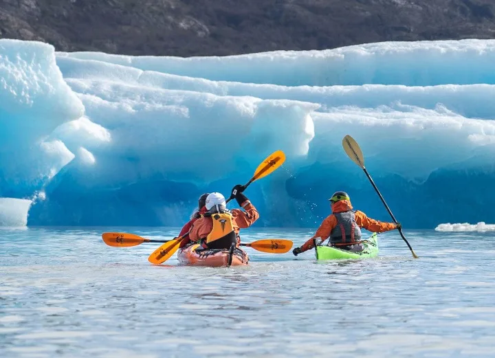 Kayakers experiencing one of the many kayaking trips across Lago Grey at Torres del Paine National Park 