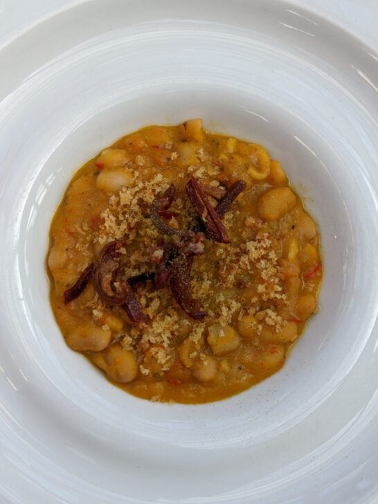 Porotos Granados is a delicious blend of white beans, squash, corn, garlic, and onions. 