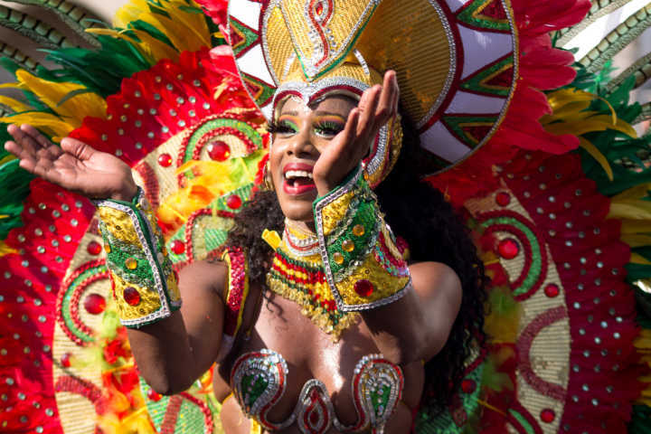 A woman in a brightly coloured festive outfit at Barranquilla carnival in Colombia