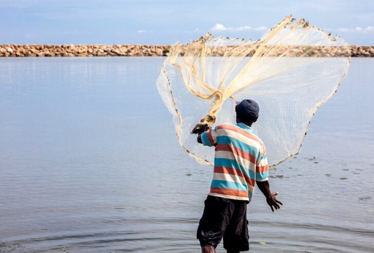 A local fisherman throwing his net in the Cienaga de Juan Polo near Cartagena, Colombia