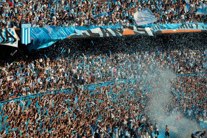Spectators dressed in blue at Boca Junions football stadium in Buenos Aires, Argentina