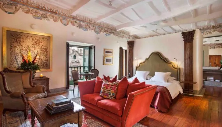A beautiful colonial-style bedroom with earth tones at Inkaterra La Casona.