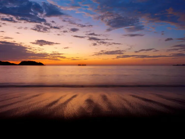 Purple skies and flowing water at sunset in Guanacaste, Costa Rica