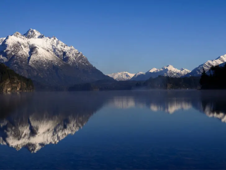 The astounding views of Lago Nahuel Huapi with the lake in the foreground, and mountains surround it in the background.