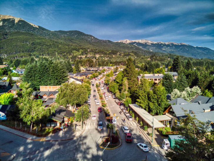The main street of Villa la Angostura in Bariloche, with mountains providing a stunning backdrop.