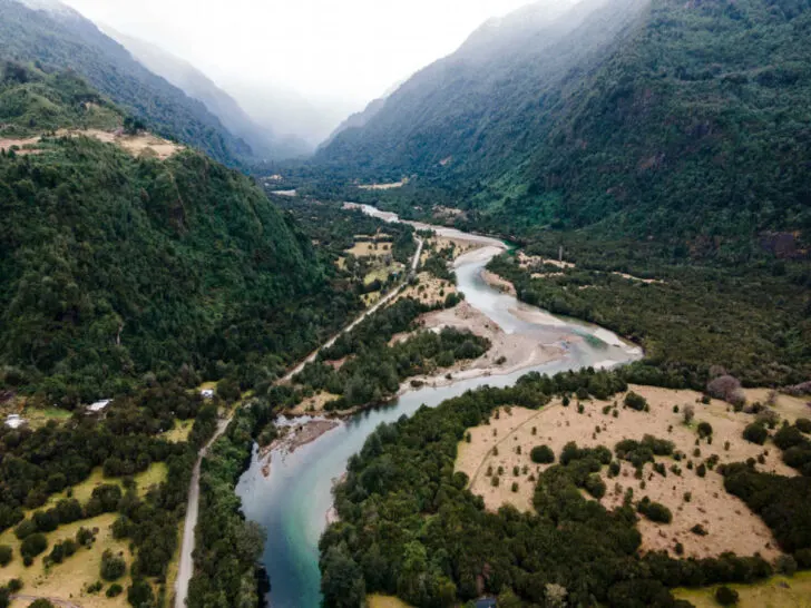 Aerial view of the Cochamo Valley with its green forest on a cloudy winter day.