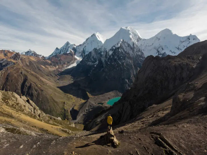 A stunning viewpoint from the Huayhuash Circuit overlooking the snowy Andes mountain, San Antonio, with the Laguna Jurau lake poking out from between the landscape