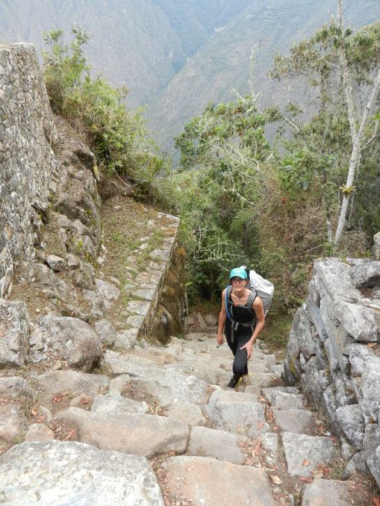 The author climbing up the Inca stone stairs on the short Inca Trail in Peru