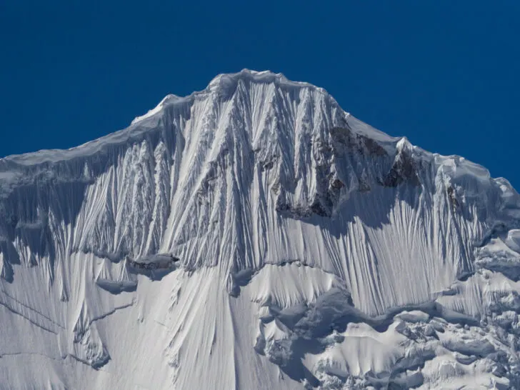 The summit peak of the Cordillera Huayhuash circuit, featuring a snowcapped mountain